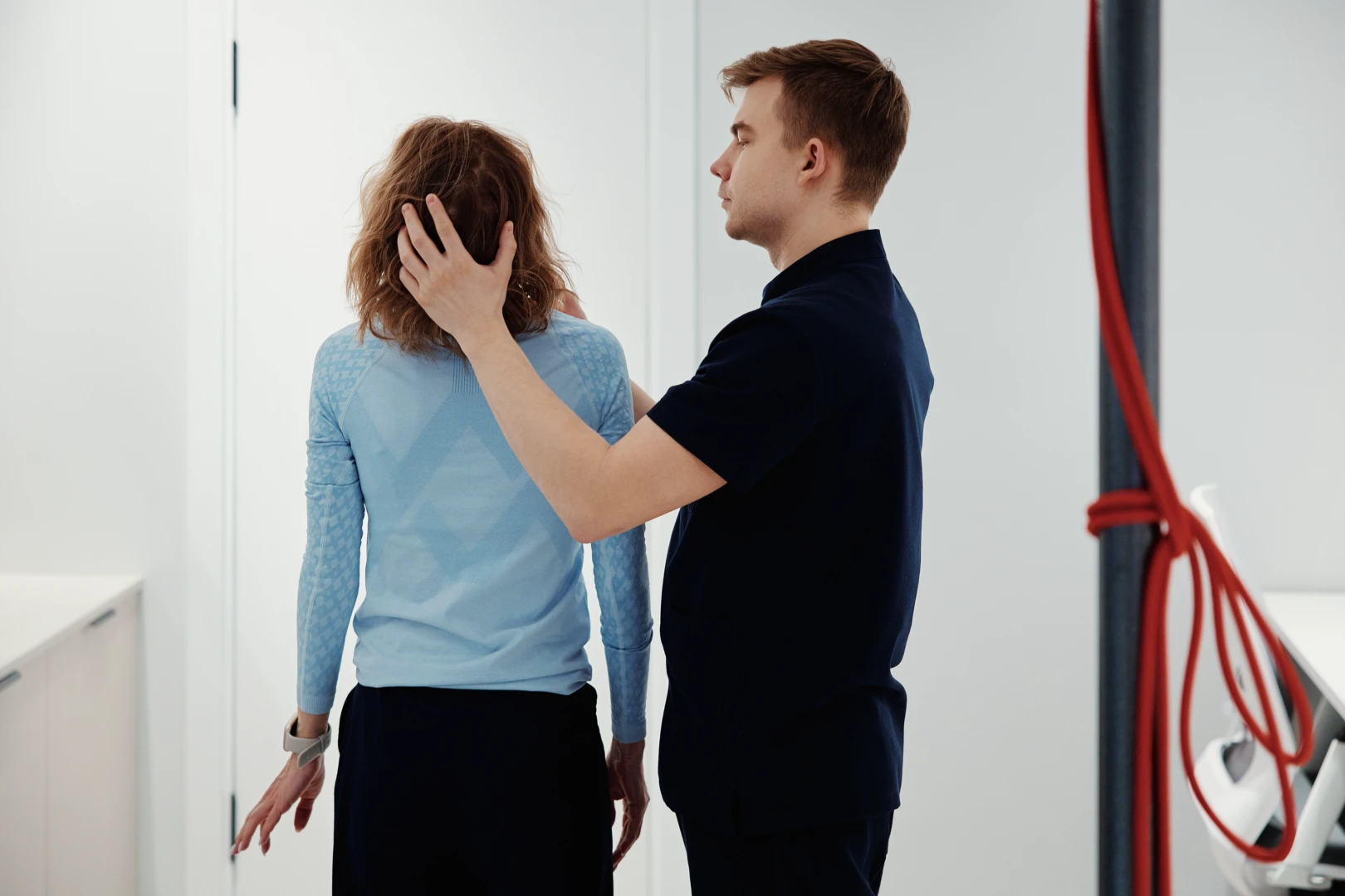 Инструктор ЛФК проводит упражнение с пациентом в Ист Клинике